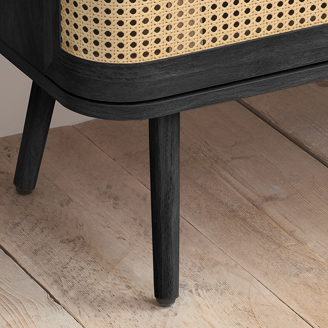 close up image on black legs of chest of drawers