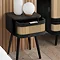 close up angled image of black side table with rattan drawer, with drawer slightly open