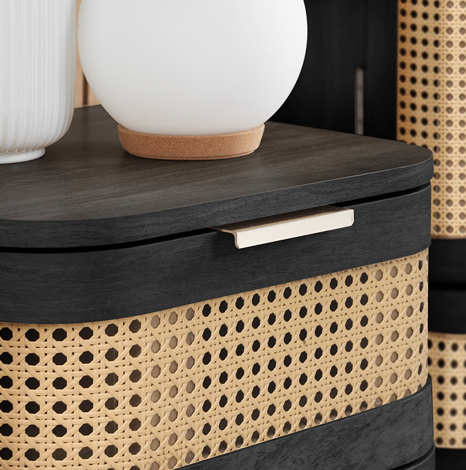 close up image of rattan style front single drawer of black bedside table