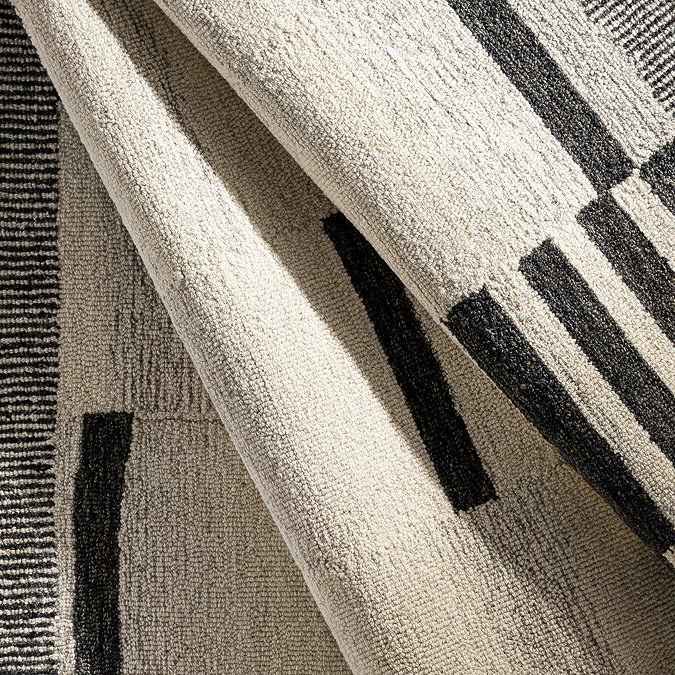 close up image of wool rug ruched up to show texture and colour