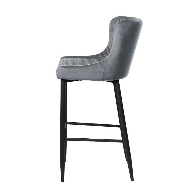 side on image cut out on white background of grey velvet bar stool with black steel legs