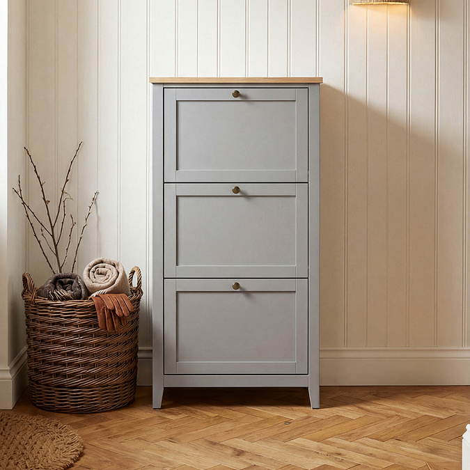 close up image of three drawer shoe storage with oak top next to basket