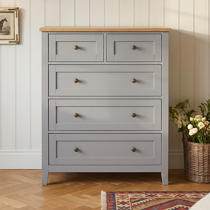 close up image of painted grey chest with five drawers and smooth oak top