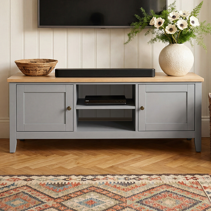 close up on two doors and shelf of painted grey tv unit