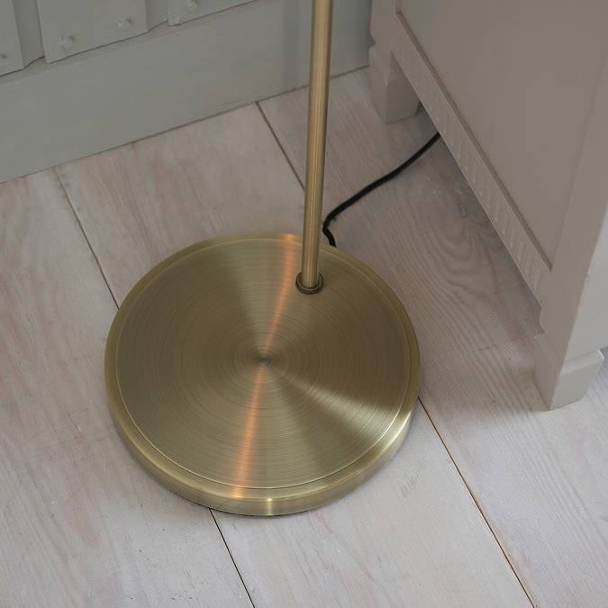 close up image of circular antique bronze base of floor lamp