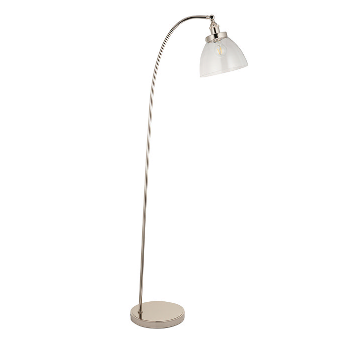 image cut out on white background of gently arched nickel floor lamp with clear shade