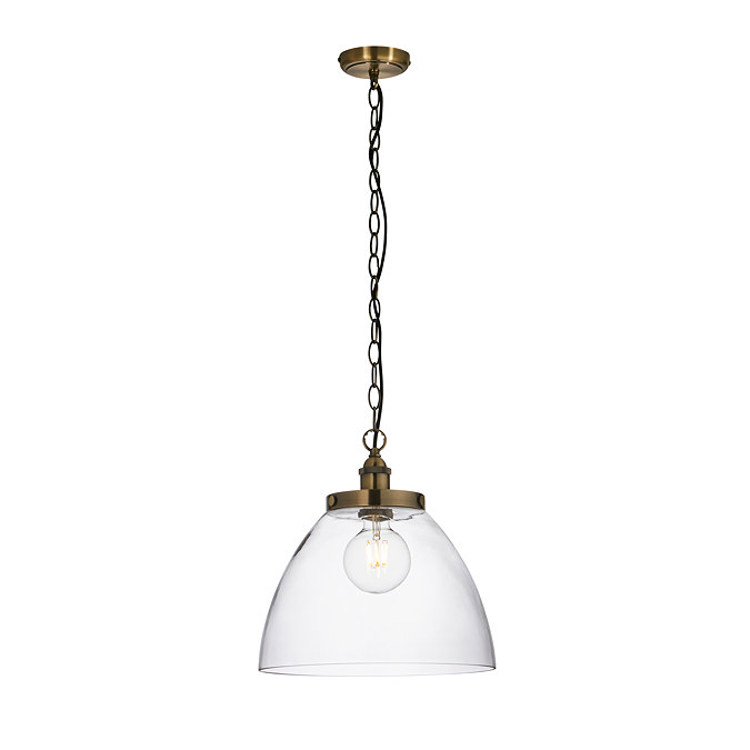 image cut out on white background of large antique brass pendant light with hanging chain and black cable