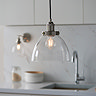 close up on image of clear glass shade of nickel pendant light in kitchen