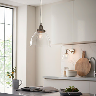 image of nickel pendant light with clear glass shade, hanging over kitchen countertop