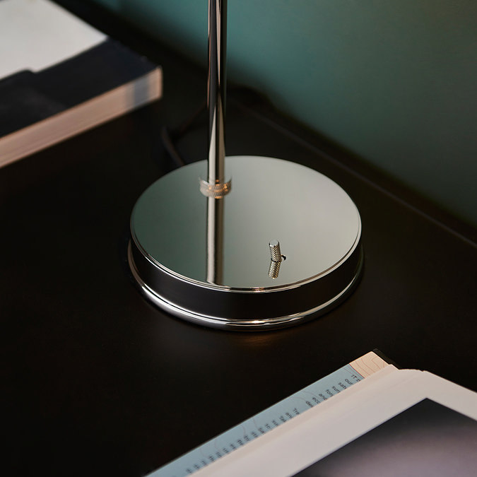 close up image on circular nickel base of table lamp