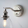 close up image of round nickel fixture of wall light