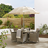 image of ecru parasol in light brown table with rattan chairs, on sunny patio