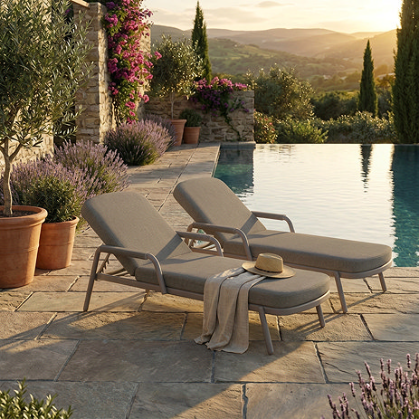 image of two plush cushioned sun loungers with aluminium frames on patio
