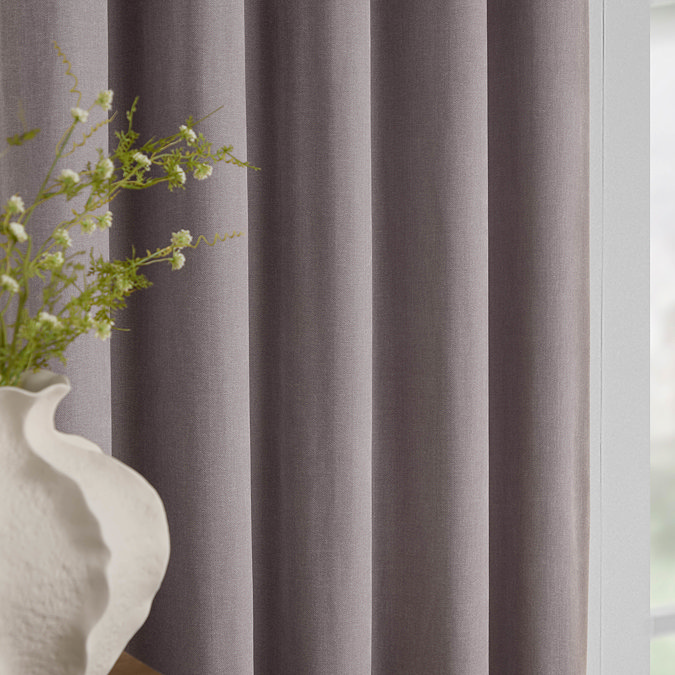 Heavy Chenille Mauve Eyelet curtains over a window close up image