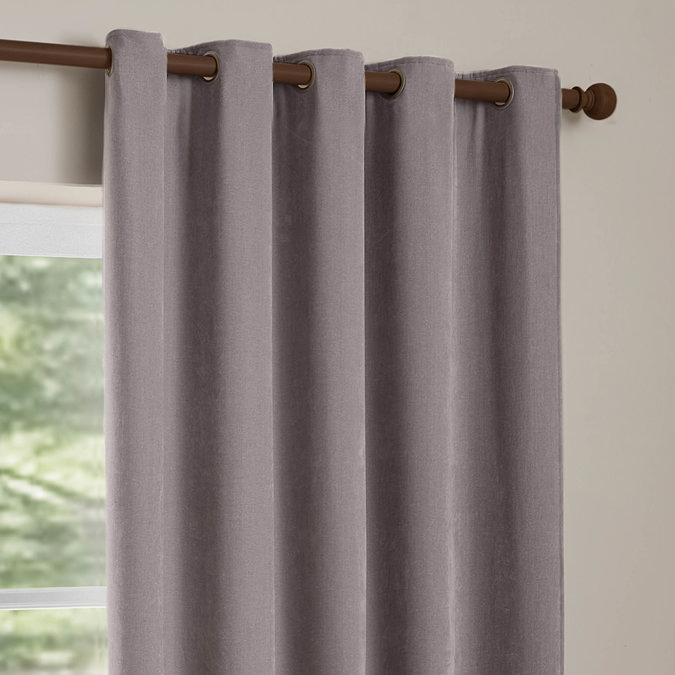 Heavy Chenille Mauve Eyelet curtains over a window close up image
