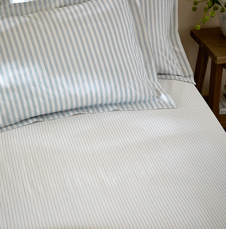 Hebden fitted sheet in mineral blue close up on bed image 1