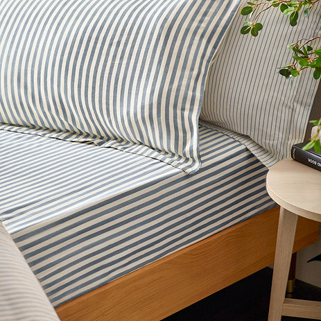 Hebden navy fitted sheet on bed image 1