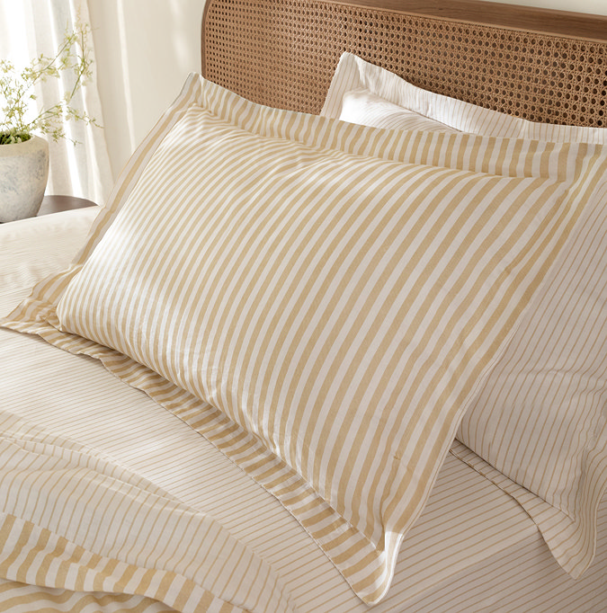 Hebden yellow pillowcase on bed image 1