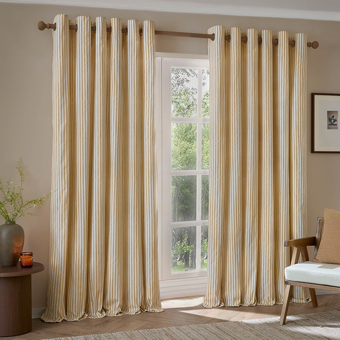 Hebden Striped Blackout Eyelet curtains in honey yellow over a window image