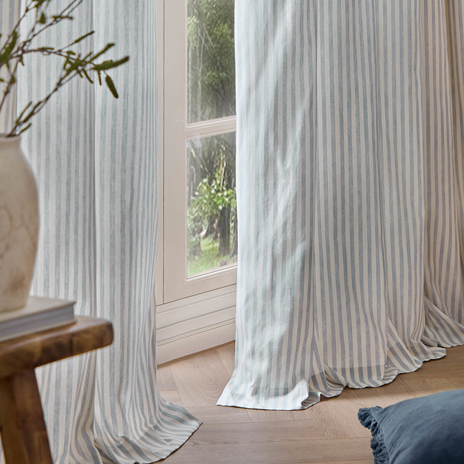 Hebden Striped Blackout Eyelet Curtains in mineral blue over a window image