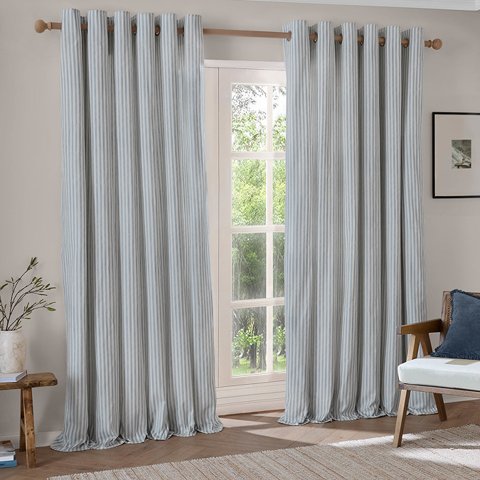 Hebden Striped Blackout Eyelet Curtains in mineral blue over a window image