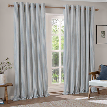 Hebden Striped Blackout Eyelet Curtains in mineral blue over a window image