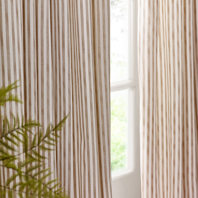 close up on middle part of striped natural curtains, emphasising elegant drape