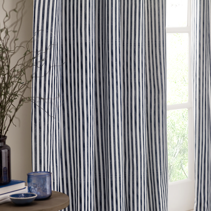 close up on navy blue striped left curtain