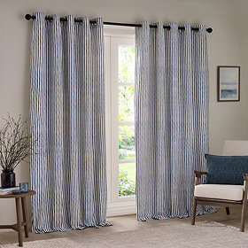 navy blue striped curtains open over a large living room window