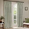 image of a pair of light green striped cotton curtains hanging, open, in front of a floor length living room window