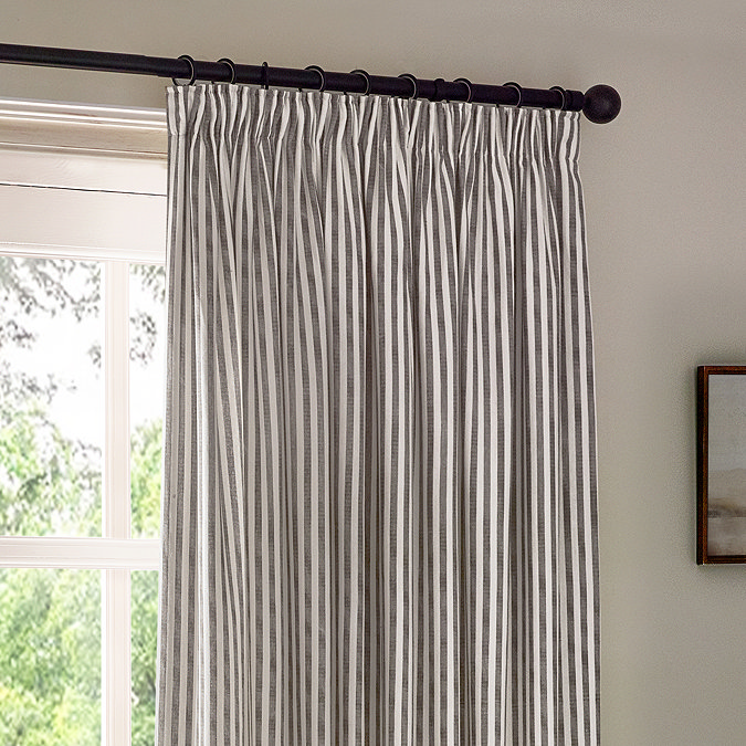 close up on top half of grey striped curtains, highlighting the pencil pleat style
