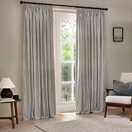 image of grey striped curtains open over a floor length living room window