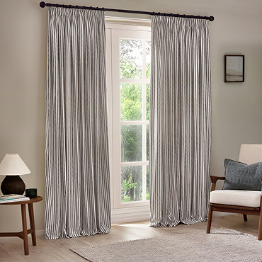 close up on top half of grey striped curtains, highlighting the pencil pleat style