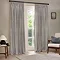 image of grey striped curtains open over a floor length living room window