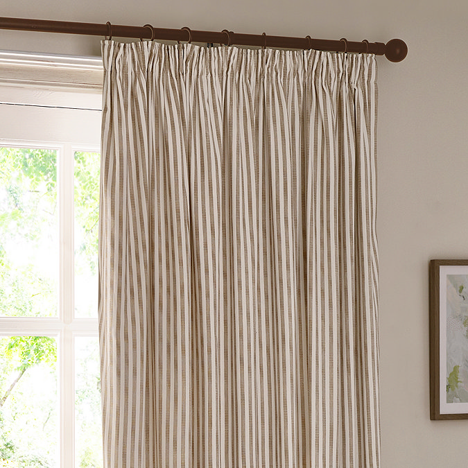 close up on natural coloured striped curtains, highlighting the pencil pleat style