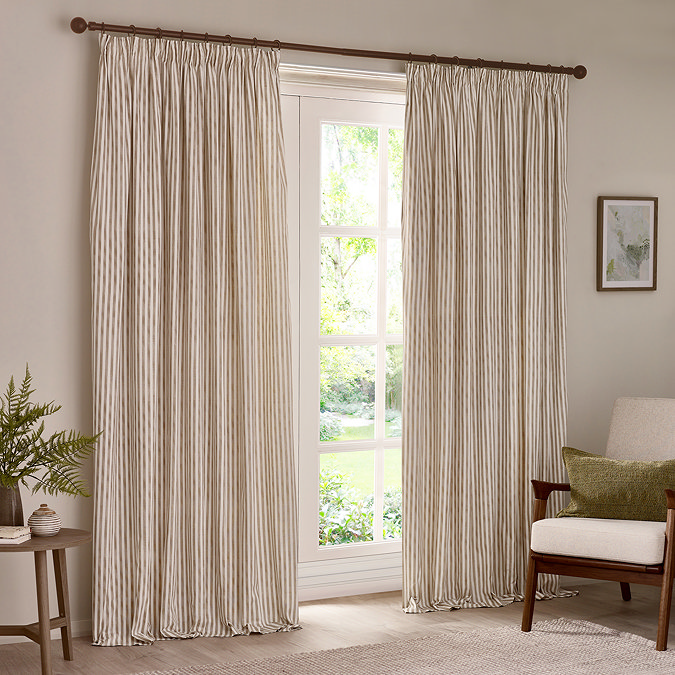 natural coloured striped curtains hanging open in front of floor length living room mirror