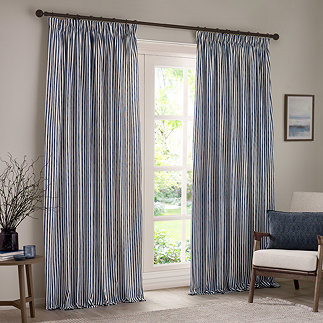 navy blue cotton striped curtains open across a floor length living room window