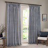 navy blue cotton striped curtains open across a floor length living room window