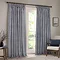 navy blue cotton striped curtains open across a floor length living room window