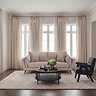 image of taupe chenille 3 seater sofa in living room in front of window