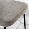 close up on natural fabric of dining chair with black metal legs