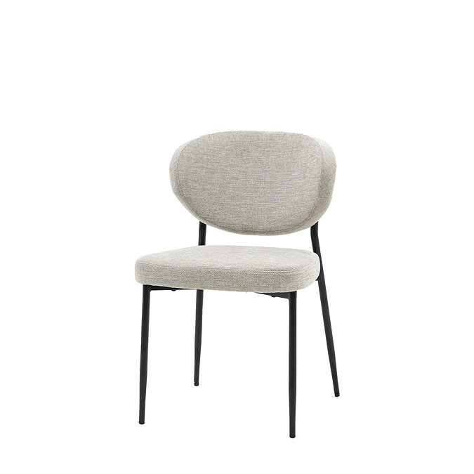 image cut out on white background of upholstered dining chair with black metal legs