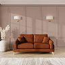 lifestyle image of medium sofa with light oak feet in mandarin fabric