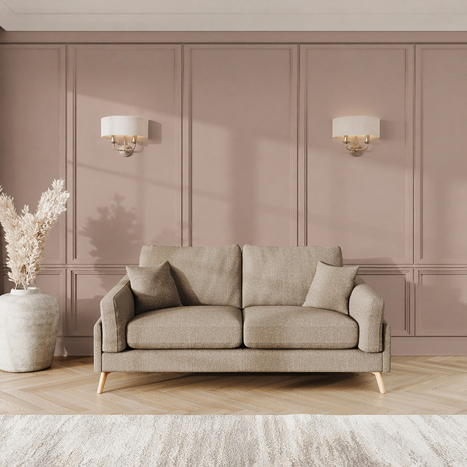 lifestyle image of medium sofa with light oak feet in latte fabric