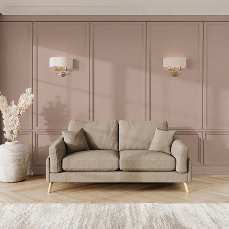lifestyle image of medium sofa with light oak feet in latte fabric
