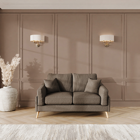 lifestyle image of small sofa with light oak feet in fallow fabric