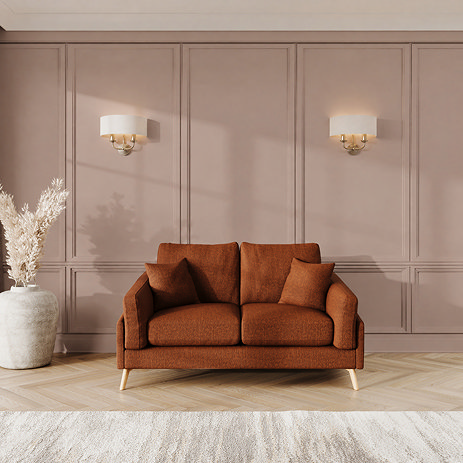 lifestyle image of small sofa with light oak feet in mandarin fabric