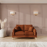 lifestyle image of small sofa with light oak feet in mandarin fabric