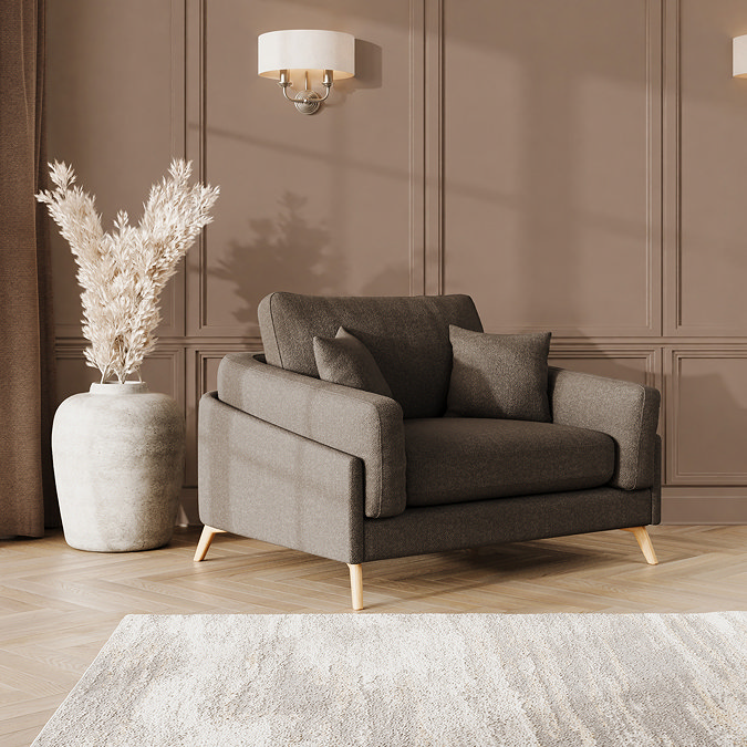 lifestyle image of snuggle chair with light oak feet in fallow fabric
