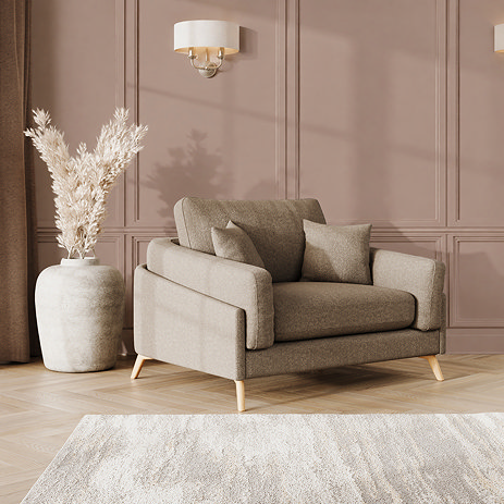 lifestyle image of snuggle chair with light oak feet in latte fabric